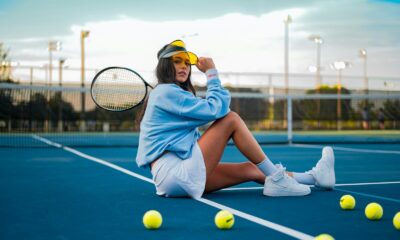 woman in blue dress sitting on tennis court