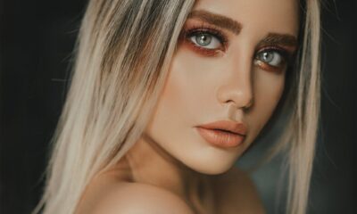 Elegant portrait of a woman with blonde hair and striking blue eyes, highlighting natural beauty.