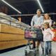 A joyful family shopping together in a supermarket aisle, enjoying their day.