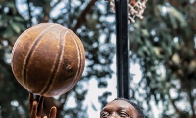 A young man enjoying playing basketball on a sunny day in Accra, Ghana.