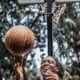 A young man enjoying playing basketball on a sunny day in Accra, Ghana.