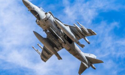 A military jet showcasing advanced technology soaring through a clear blue sky.