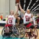 Exciting wheelchair basketball game showcasing talent and teamwork indoors.