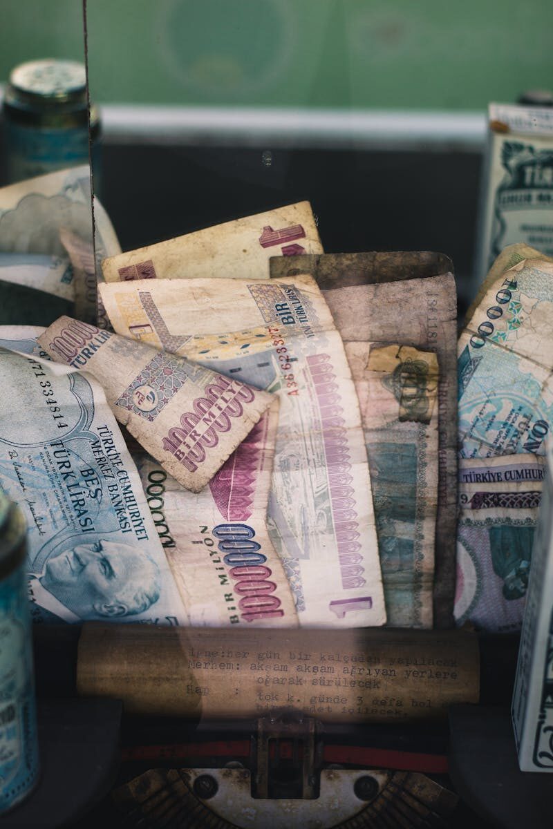 Close-up of old Turkish lira banknotes in a cash box, symbolizing financial history and currency collection.