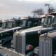 Classic Kenworth trucks lined up outdoors, showcasing heavy-duty retro design.