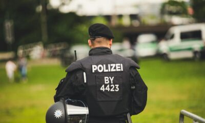 A police officer stands in uniform outdoors, highlighting law enforcement.