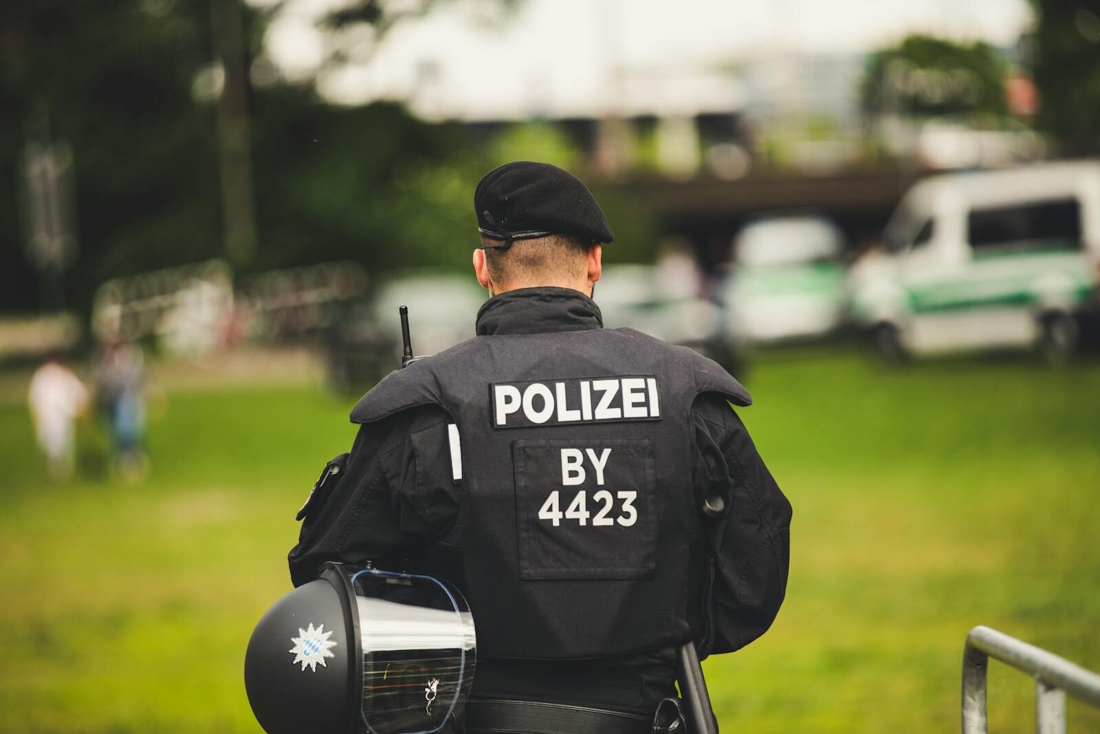 A police officer stands in uniform outdoors, highlighting law enforcement.