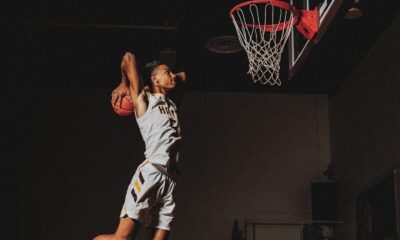 2 boys playing basketball on basketball court