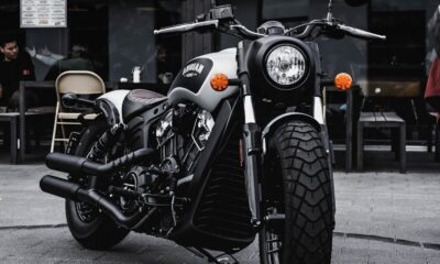 black and gray cruiser motorcycle parked beside black concrete building