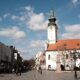 A picturesque view of the historic town square and Town Hall in Sombor, Serbia, under a bright sky.