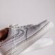 Minimalist close-up of fashionable white sneakers, perfect for modern lifestyle themes.