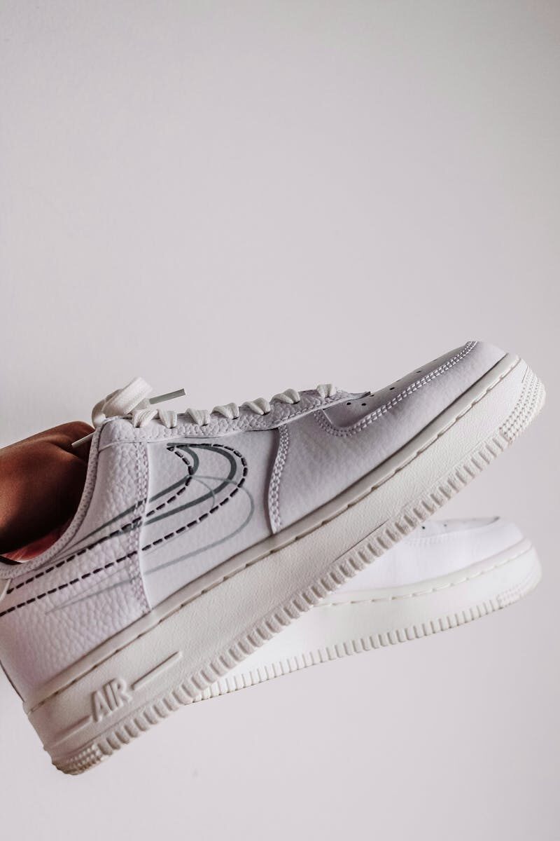 Minimalist close-up of fashionable white sneakers, perfect for modern lifestyle themes.