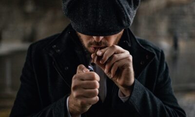 man in black knit cap smoking cigarette