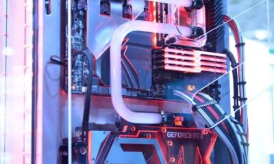 Close-up view of a custom gaming PC with water cooling and LED lights, highlighting advanced technology.
