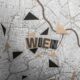 Abstract top view of Vienna map with artistic geometric cutouts, highlighting 'Wien.'