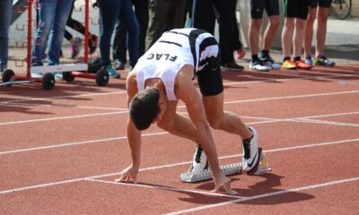 a person kneeling on a track