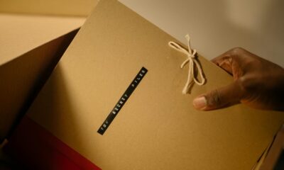 Close-up of hand holding top secret document folder in a box.
