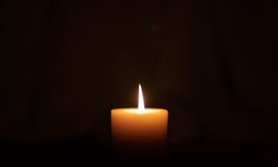 lighted candle in dark room