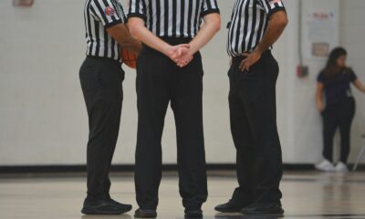 A group of men standing on top of a basketball court