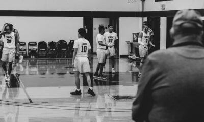 grayscale photography of players inside court