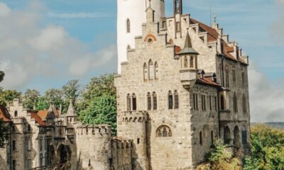white concrete building near green trees under blue sky during daytime