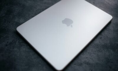 Closed silver laptop with apple logo on dark surface