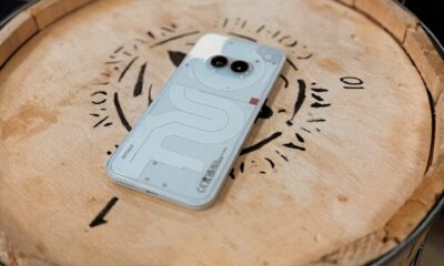 a cell phone sitting on top of a wooden barrel