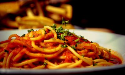 a plate of spaghetti with tomato sauce and parsley