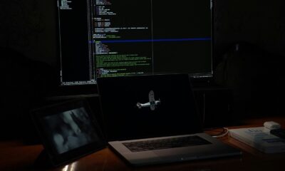 a laptop computer sitting on top of a wooden desk