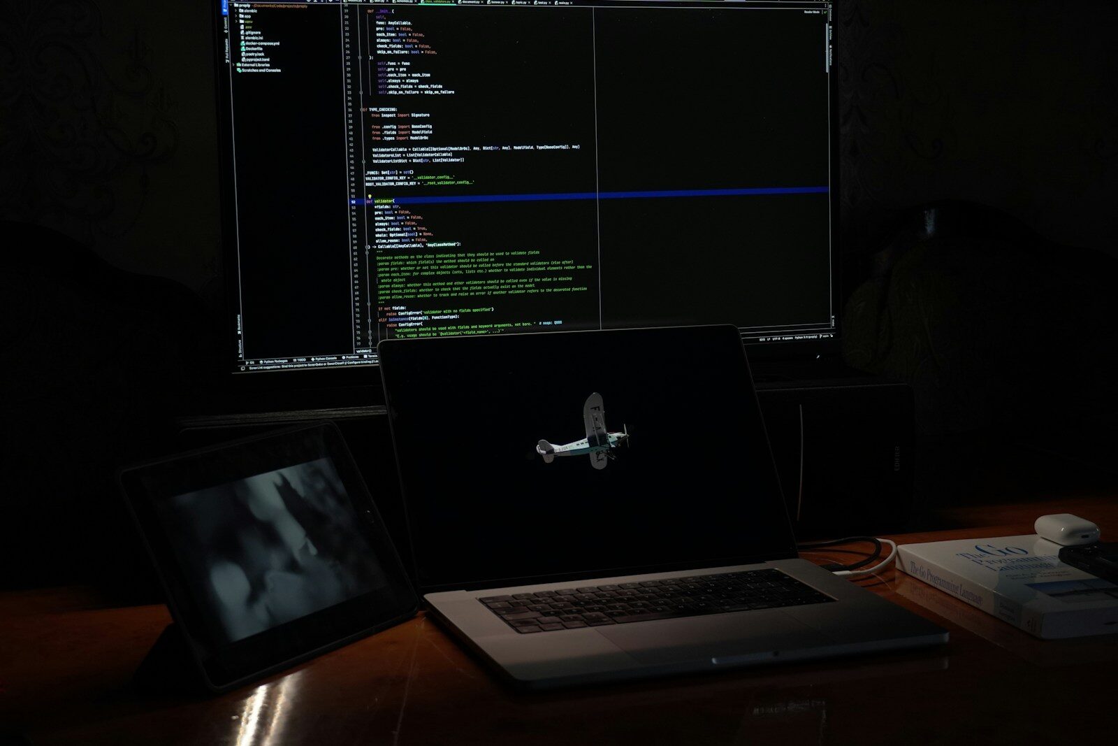 a laptop computer sitting on top of a wooden desk
