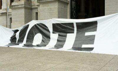 A large sign that says vote on it