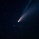 a comet is seen in the night sky