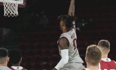 2 men in white and red jersey shirt playing basketball
