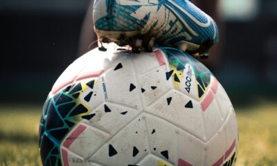 white and blue soccer ball on green grass field