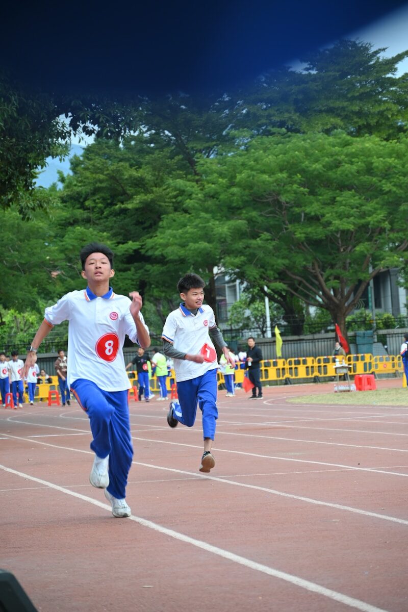 Two young boys race on a track.