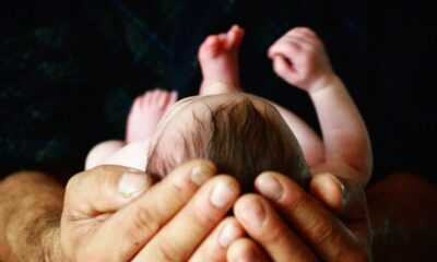 person holding babys hand