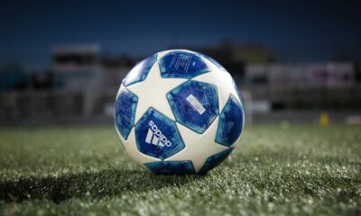 white and blue soccer ball on green grass field