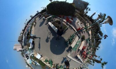 a small island in the middle of a blue sky