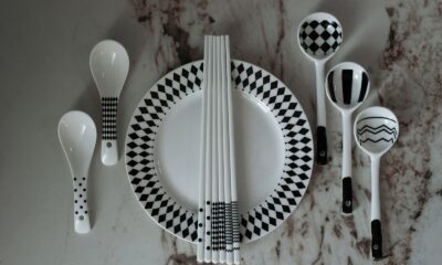 A table with a plate, spoons, and utensils on it