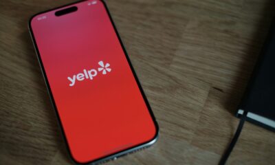 A cell phone sitting on top of a wooden table