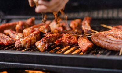 a person is cooking meat on a grill