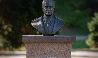 A bronze bust of Josip Broz Tito on a stone pedestal in Gradačac, Bosnia and Herzegovina.