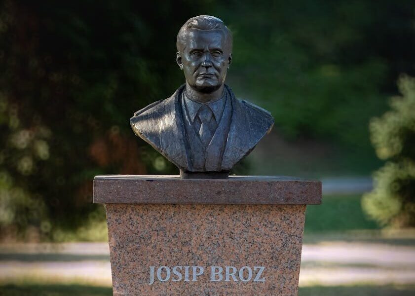 A bronze bust of Josip Broz Tito on a stone pedestal in Gradačac, Bosnia and Herzegovina.