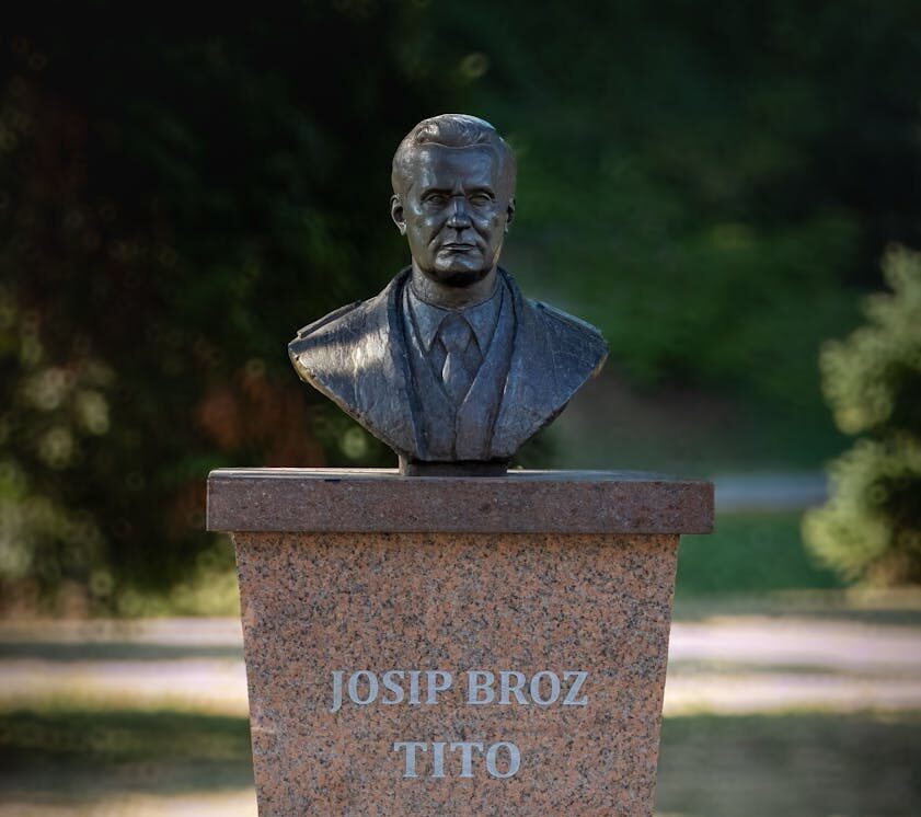 A bronze bust of Josip Broz Tito on a stone pedestal in Gradačac, Bosnia and Herzegovina.