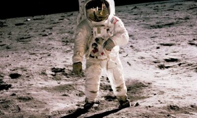 astronaut standing on gray sand