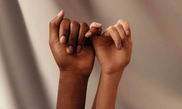 persons hand with white manicure