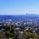 Captivating view of Los Angeles skyline under clear blue skies from a scenic overlook.