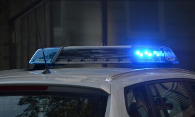 Close-up of a police car's flashing blue lights in an urban environment.