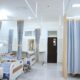 Clean and modern hospital ward with beds and privacy curtains in Surabaya, Indonesia.