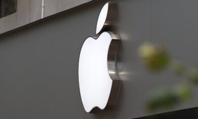 Close-up of Apple Store exterior featuring the illuminated logo prominently displayed.